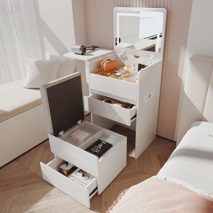 an open drawer in the middle of a bed next to a white dresser with drawers