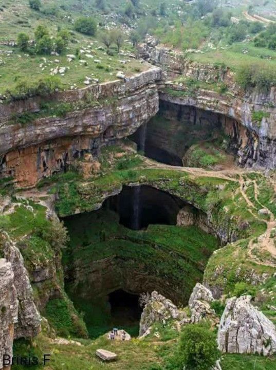 a large cave in the middle of a mountain