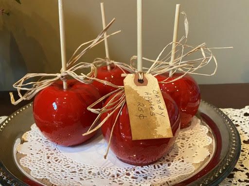 two apples are wrapped in twine and sitting on a plate with a price tag