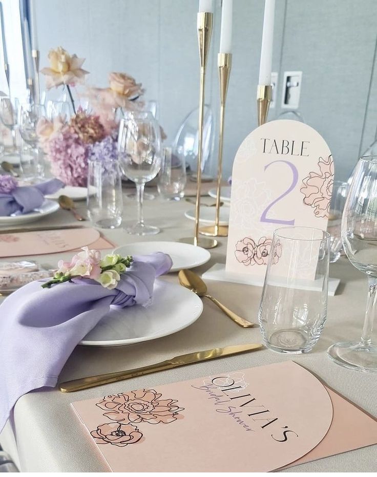 the table is set with place cards and wine glasses