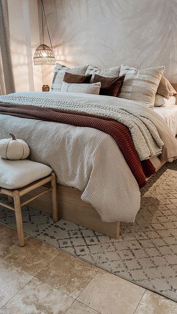 a bedroom with a large bed and white walls