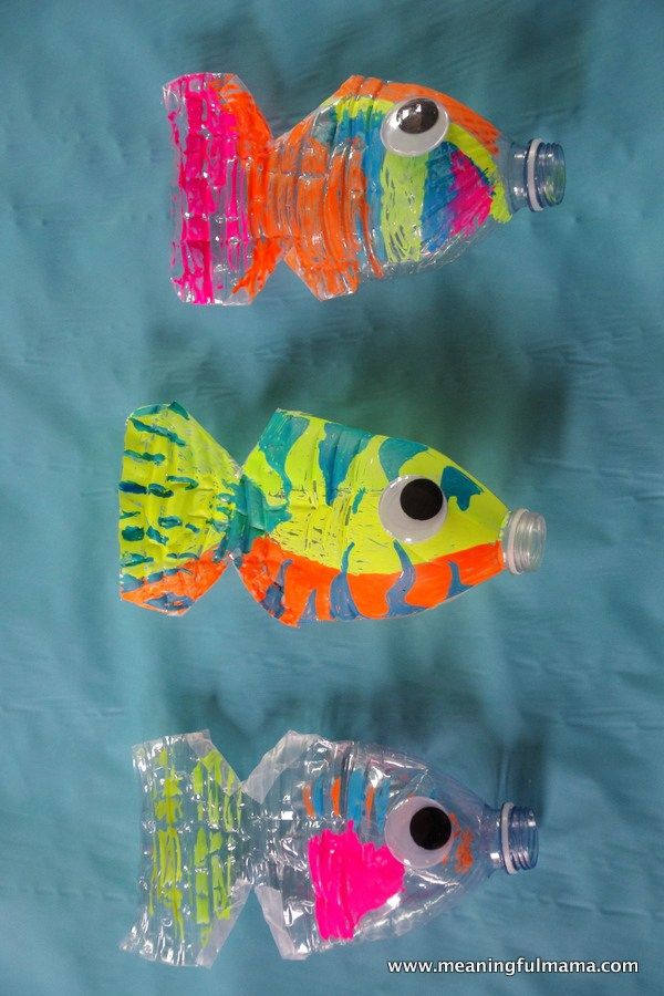 three plastic fish shaped like water bottles sitting next to each other