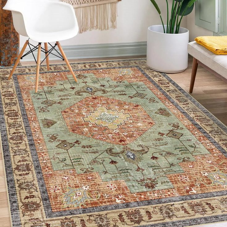 an area rug in a living room with chairs and a plant on the floor next to it