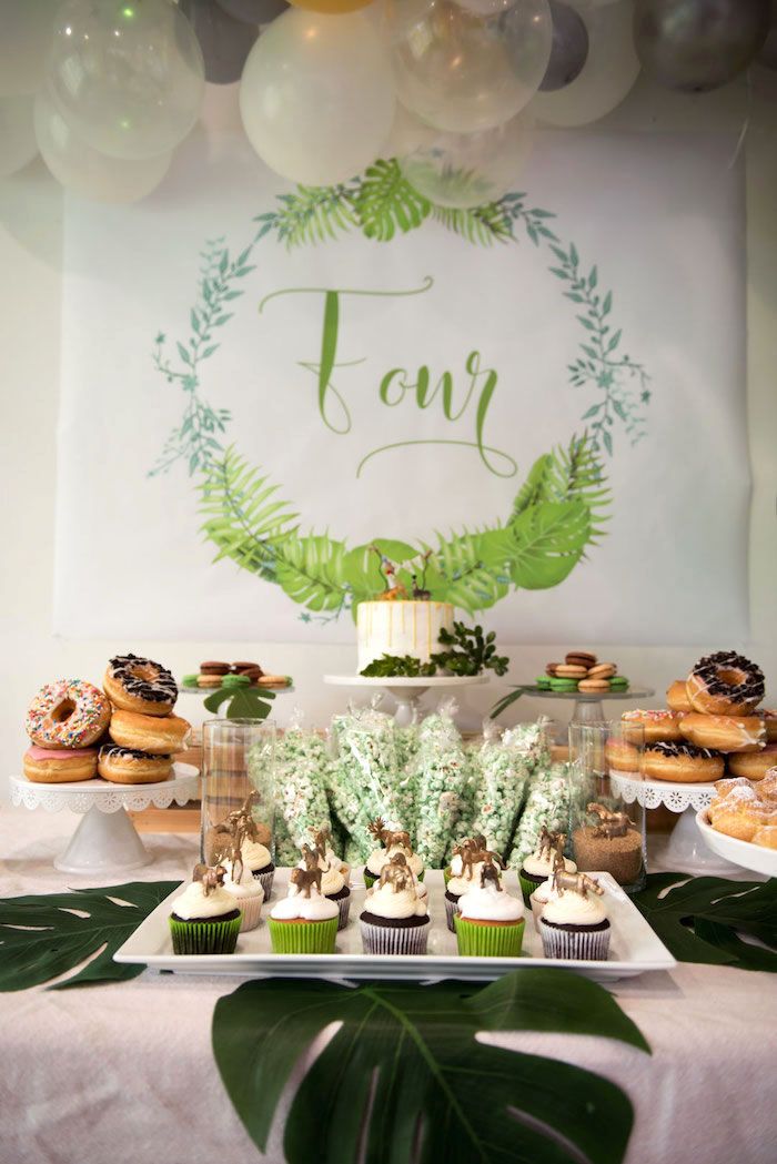 a table topped with cupcakes and desserts