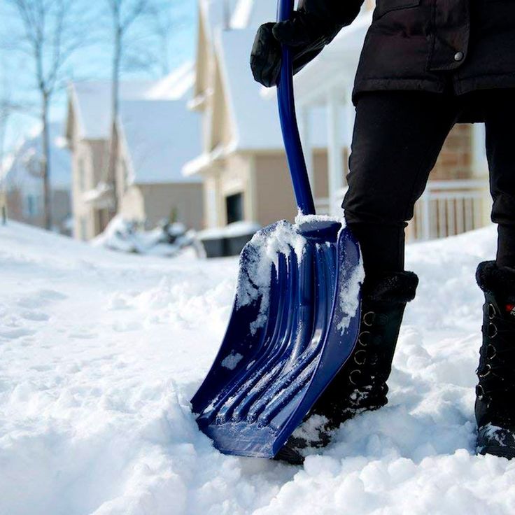 a person holding a shovel in the snow