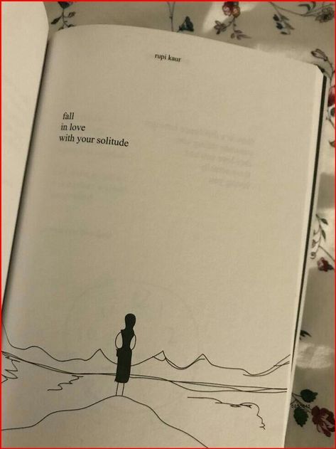 an open book with a drawing of a person standing on top of a hill in the background