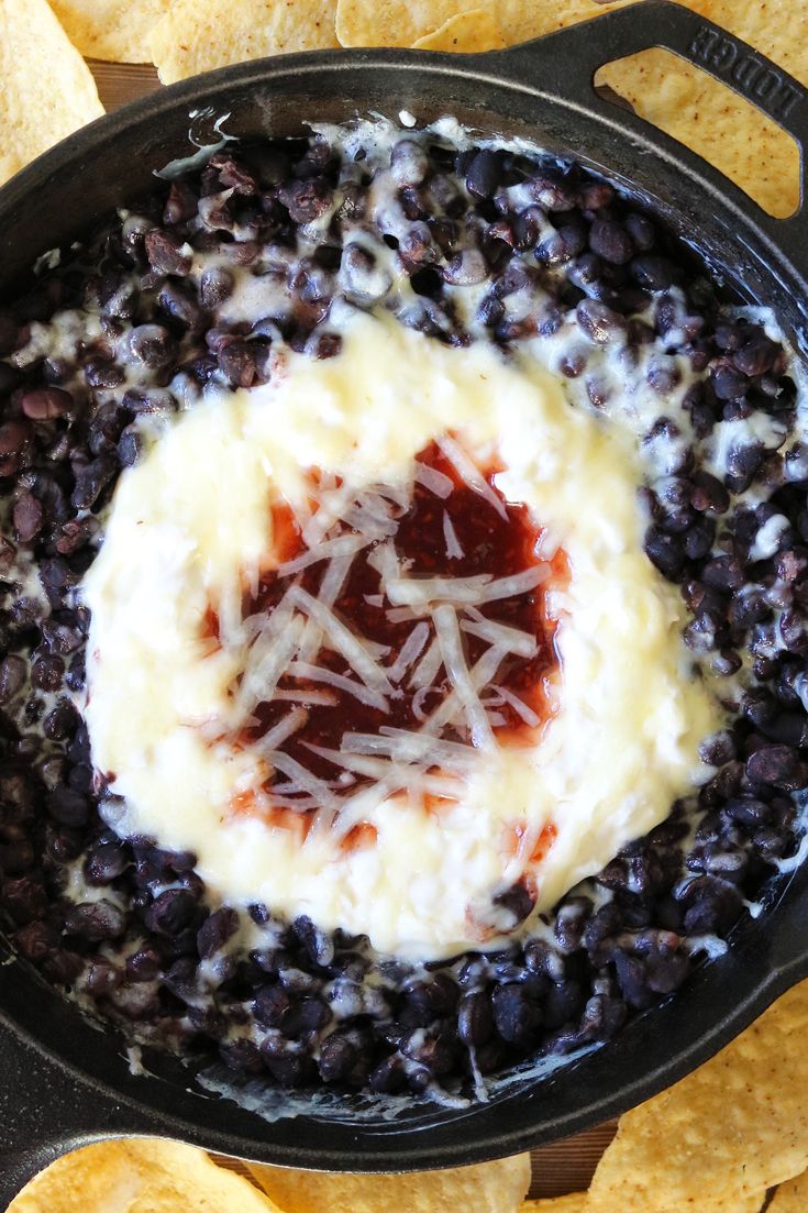 black beans and cheese in a skillet with tortilla chips