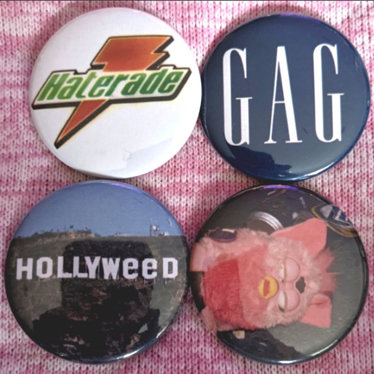 three buttons with the words hollywood, gas and cat on them are sitting next to each other