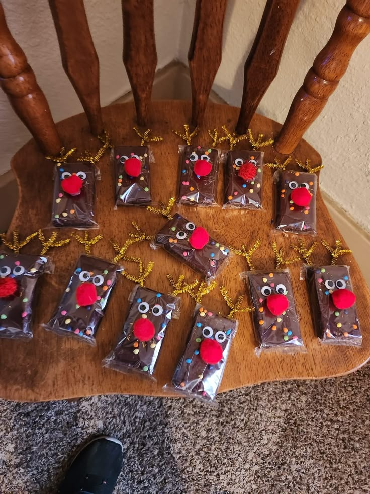 chocolate bars decorated with red and white decorations on a wooden chair next to a pair of black shoes