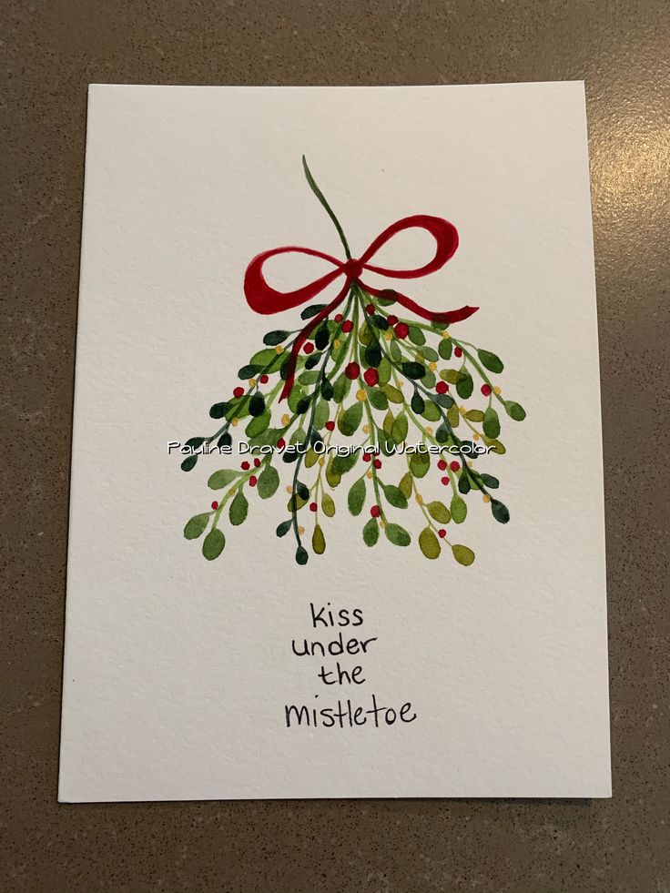 a card with a red bow and mistlet on it