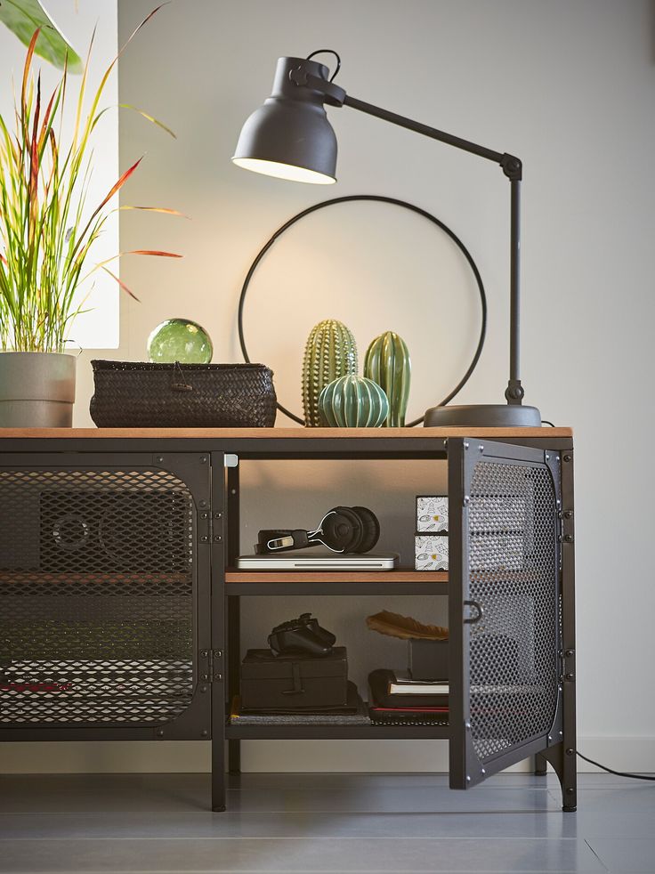 a desk with a lamp and some plants on it