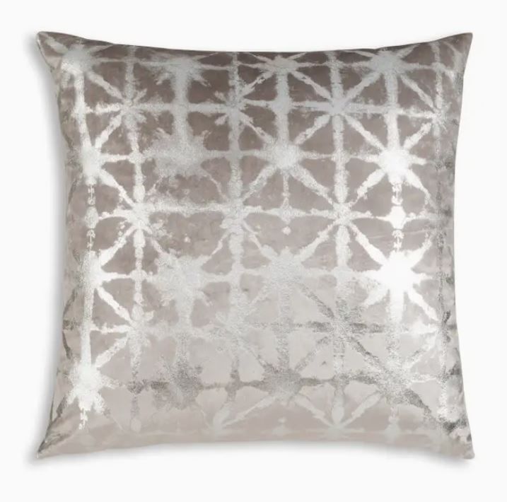 a gray and white pillow with silver foil on the front, featuring an abstract design