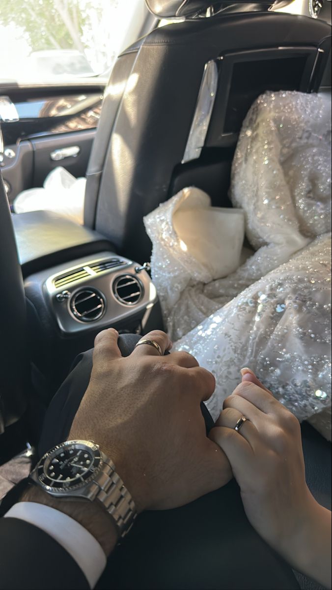 a man in a suit and tie sitting in the back seat of a car