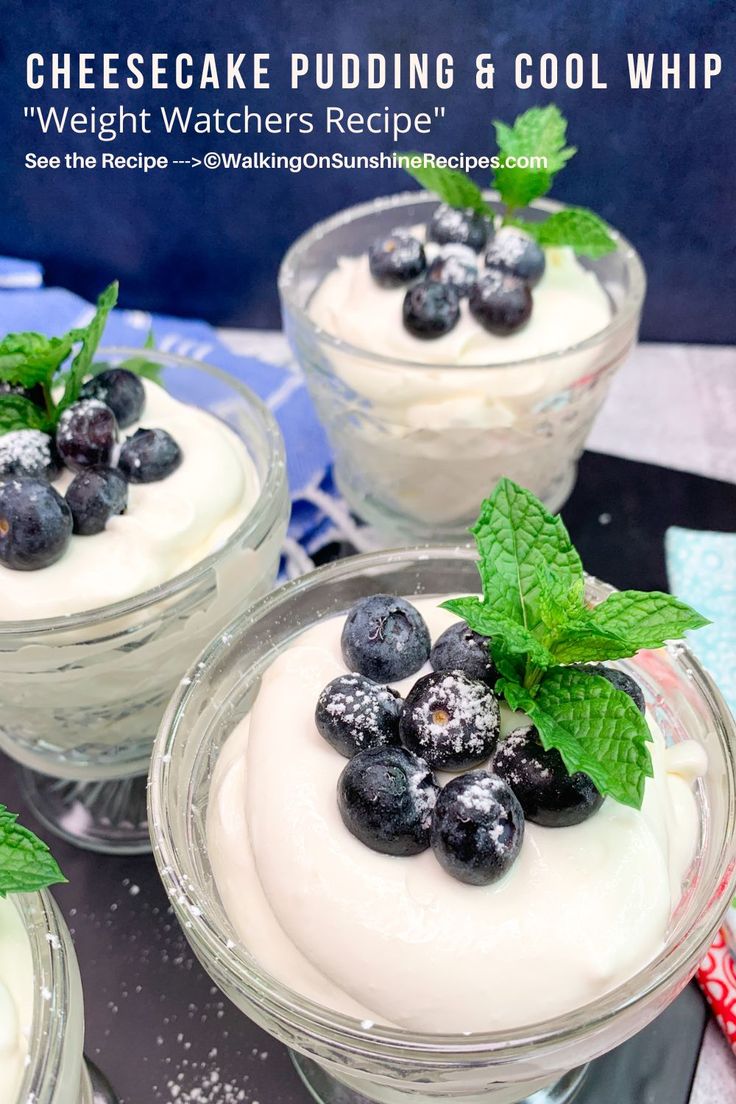 three desserts with blueberries and whipped cream in small glass dishes on a table