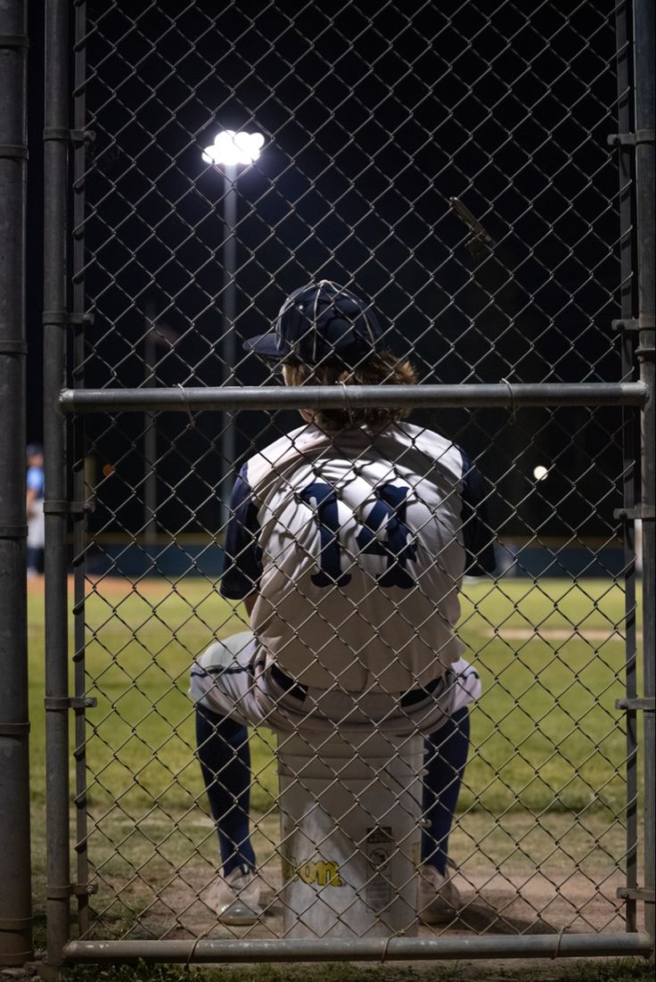 This photo contains a high school male sitting on an upside down bucket at night on the baseball field with only the stage lights on. The photo shows his uniform number which is #14. 90s Baseball Aesthetic, Baseball Practice Aesthetic, Baseball Astethic, High School Baseball Aesthetic, College Baseball Aesthetic, Highschool Baseball Aesthetic, Baseball Editorial, Highschool Baseball, Baseball Player Aesthetic