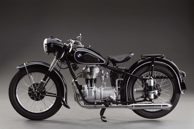 an antique motorcycle is shown in black and white