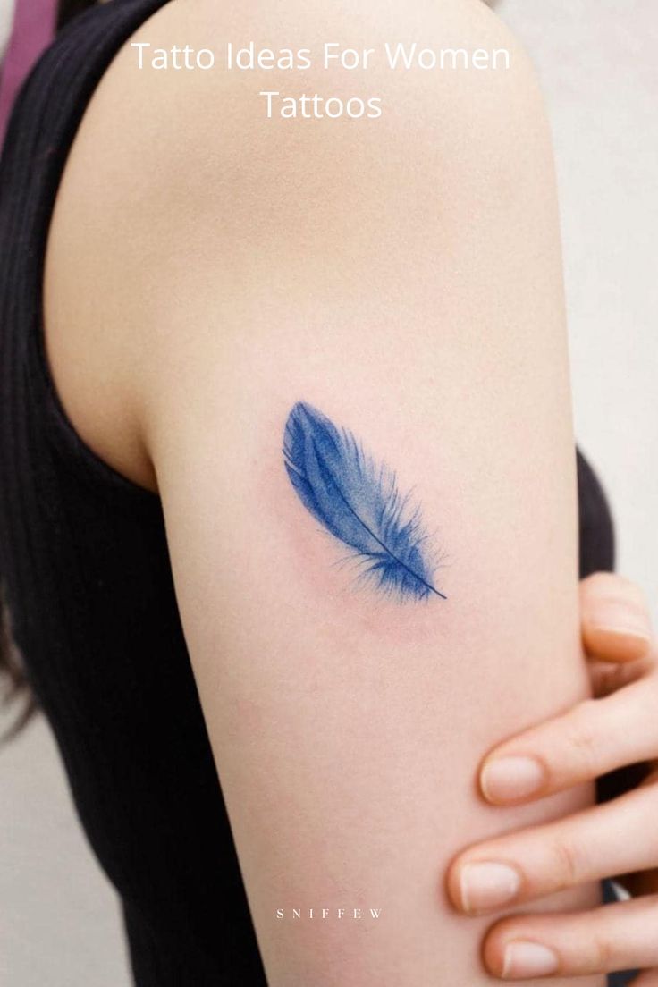 a woman's arm with a blue feather tattoo on the left shoulder and right arm