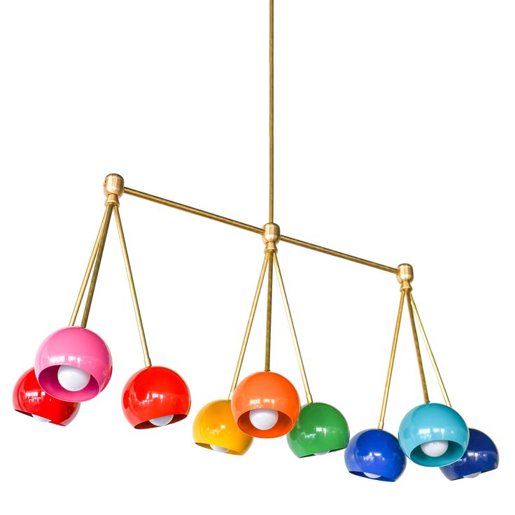 an assortment of colorful balls hanging from a brass chandelier with four different colors