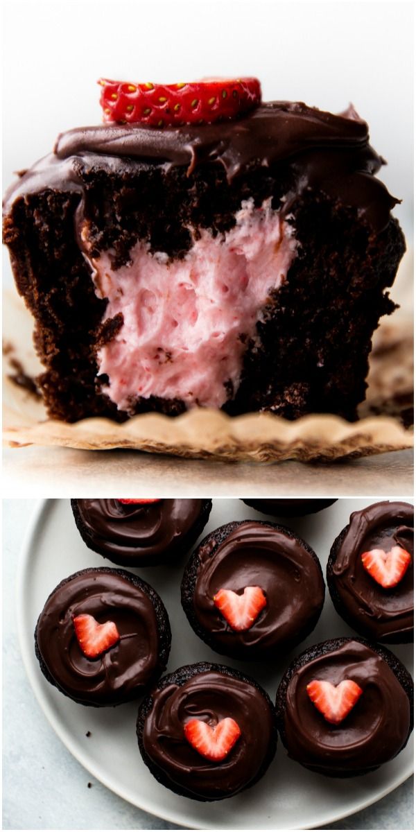 chocolate cupcakes with strawberries on top, and one half eaten strawberry in the middle