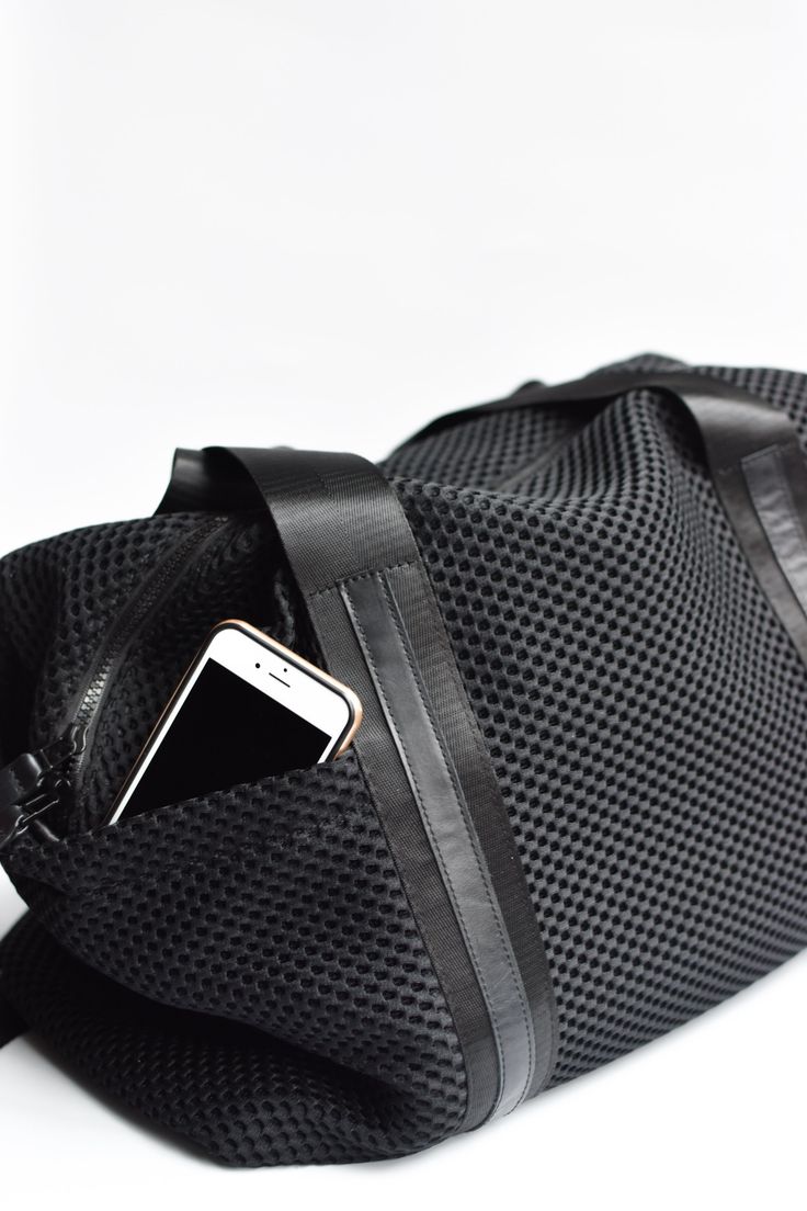 This mesh duffel bag has loads of pockets and interior organization. The perfect bag for daily workouts and weekend adventures. Black mesh with our signature leather trim and handles, finished off with a leather bottom, removable shoulder strap and easy to clean glossy liner. Content:- Mesh- Leather- Imported Size:- Width: 18" - Height: 12"- Depth: 7"- Handle Drop: 10" Nylon Duffle Bag With Zipper Pocket For Everyday, Functional Duffle Bag Tote With Zipper Pocket, Sporty Nylon Duffle Bag For Everyday Use, Sporty Nylon Shoulder Travel Bag, Sporty Duffle Bag With Luggage Sleeve For Daily Use, Sporty Satchel Travel Bag For Daily Use, Functional Duffle Bag With Zipper Pocket, Sporty Nylon Duffle Bag With Luggage Sleeve, Sporty Weekender Bag With Zipper Pocket For Travel