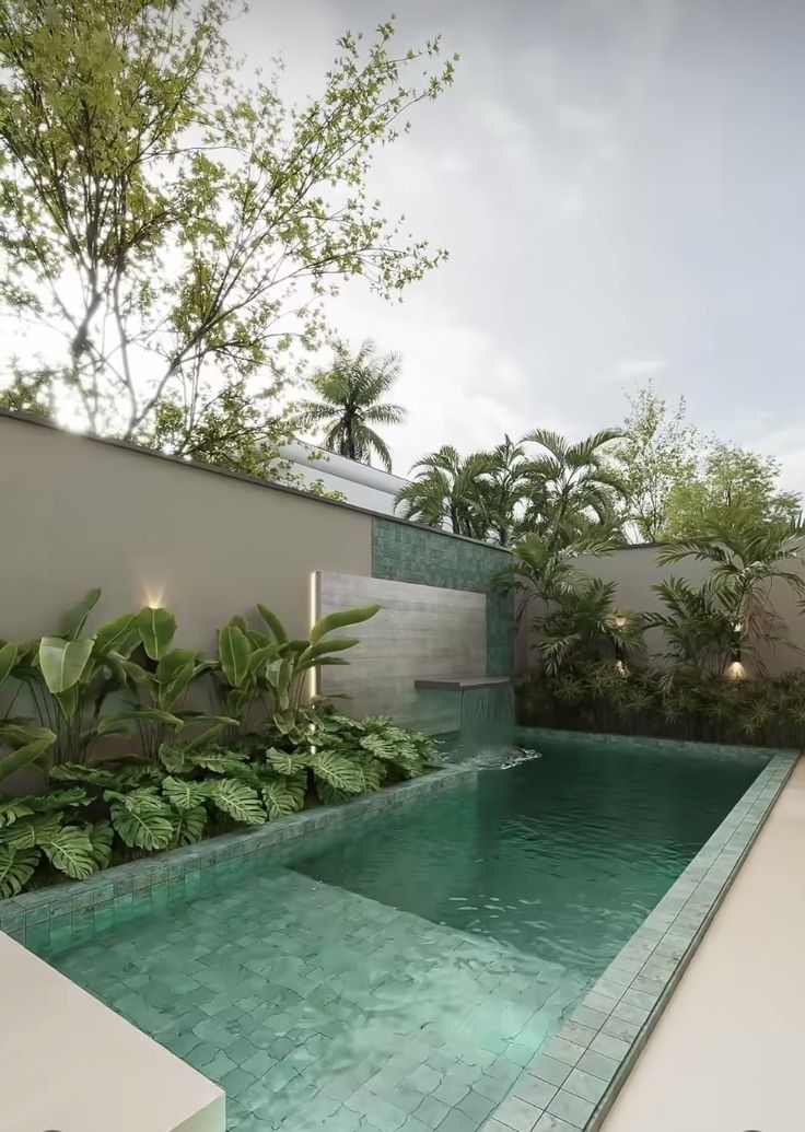 an outdoor swimming pool surrounded by greenery