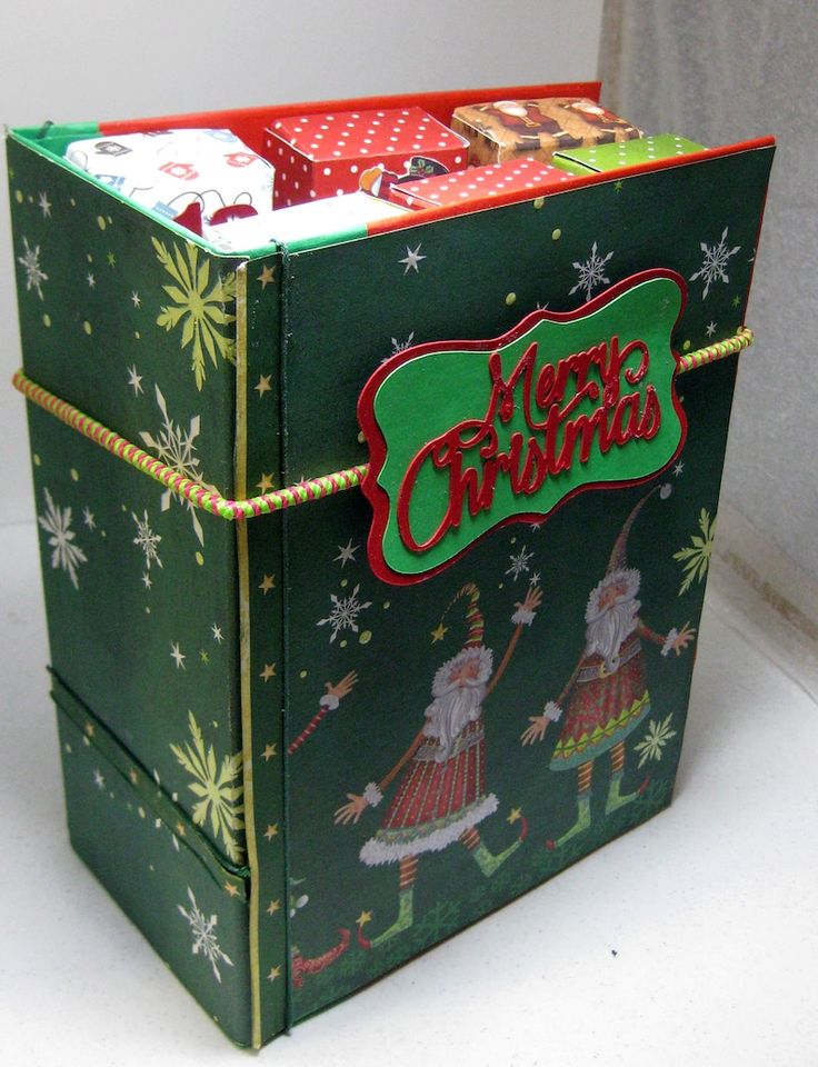 a green christmas box with santa claus on it