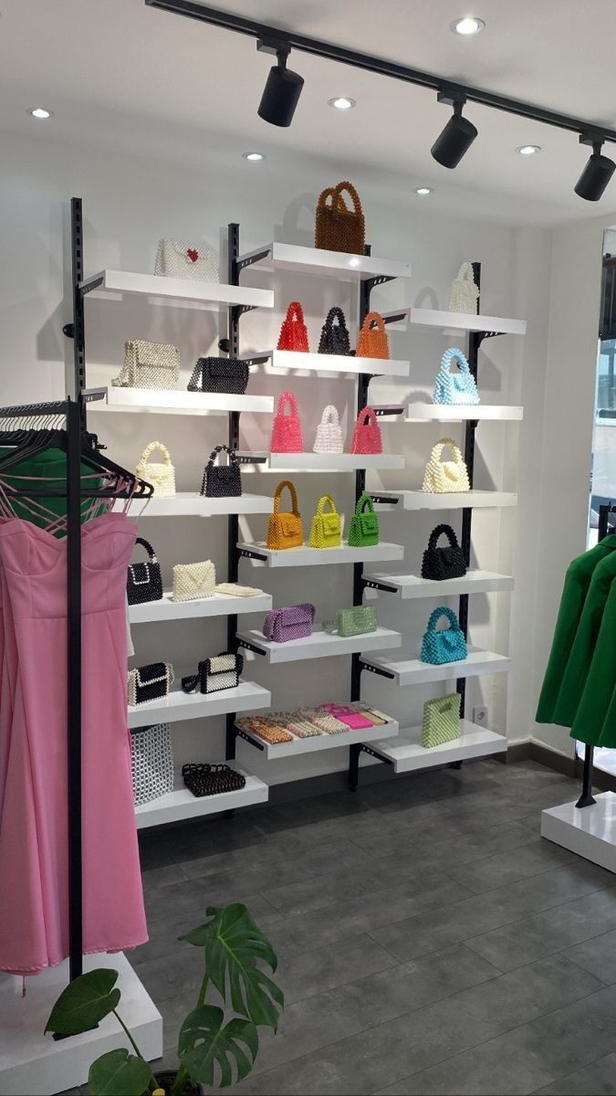 there are many purses and handbags on the shelves