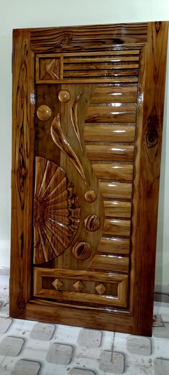 an intricately carved wooden door in the shape of a fish on a tile floor