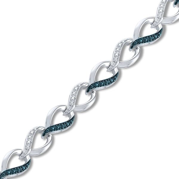 A mesmerizing combination of diamond accents in white and blue diamonds set this bracelet apart. The stunning 7.5-inch bracelet is fashioned in sterling silver and secures with a lobster clasp. Blue diamonds are treated to permanently create the intense blue color. Fine Jewelry White Diamond Bracelet With Accents, White Diamond Bracelet With Diamond Accents Fine Jewelry, White Diamond Bracelet With Diamond Accents, White Diamond Accent Bracelet For Anniversary, White Bracelet With Diamond Accents For Anniversary, White Bracelets With Diamond Accents For Anniversary, Blue Bracelets With Diamond Accents For Gift, Anniversary White Bracelet With Diamond Accents, Blue Diamond Sterling Silver Bracelet