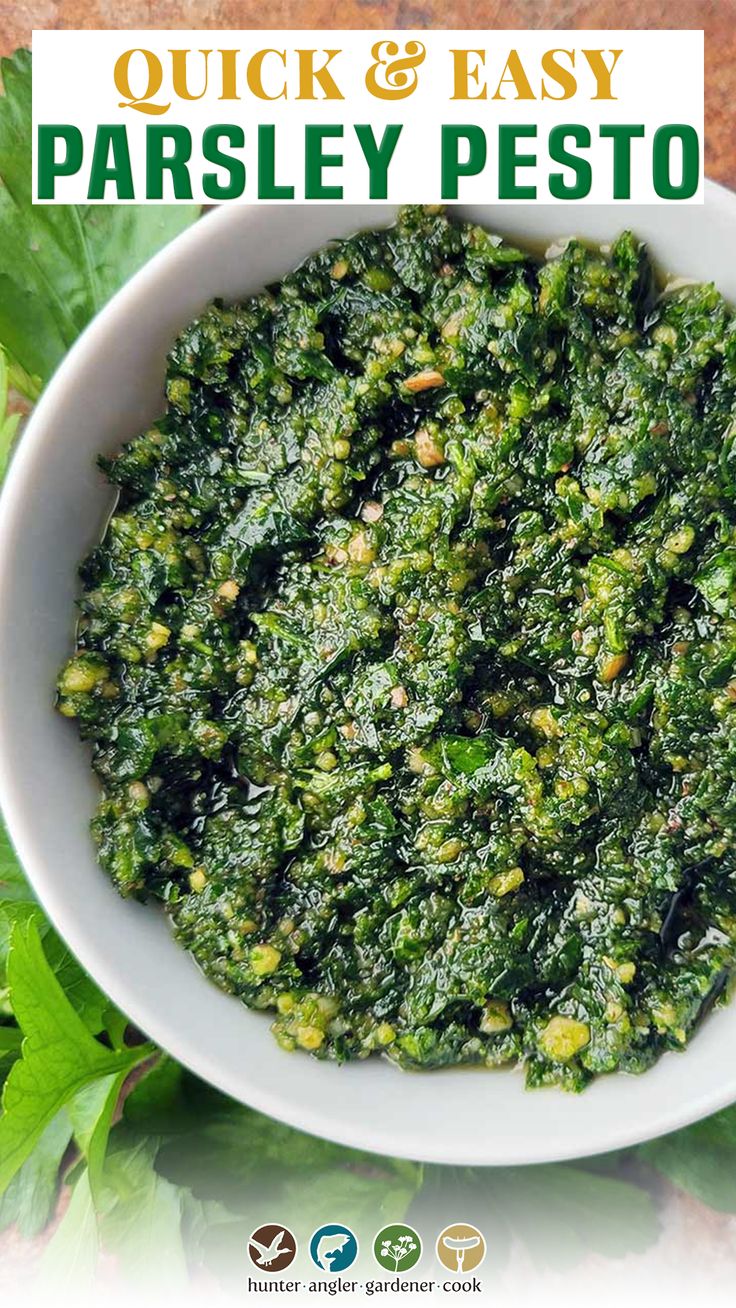 a white bowl filled with pesto on top of a table