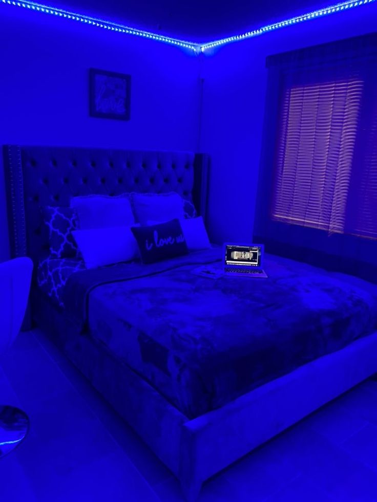 a bed in a room with blue lights