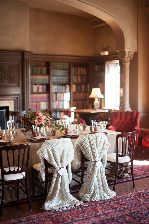 the dining room is decorated with white linens and red chairs, along with an antique rug