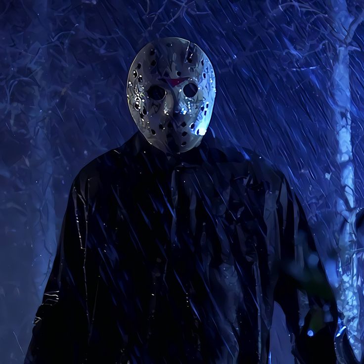 a person wearing a mask standing in the rain with trees and snow behind them at night