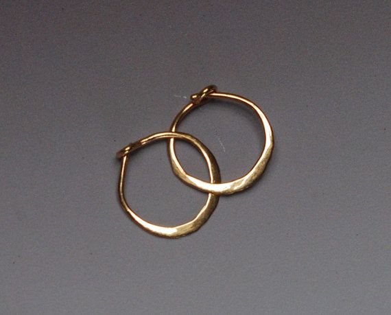 Hand forged out of solid 14 karat yellow gold wire, this pair of tiny everyday hoops has a secure locking clasp. There is an artisan ball peen 14k Gold Hoop Earrings, Small Gold Hoops, Diamond Hoop Earrings, Gold Hoops, Pretty Jewellery, Gold Hoop, Copper Jewelry, Gold Hoop Earrings, Silver Hoop Earrings