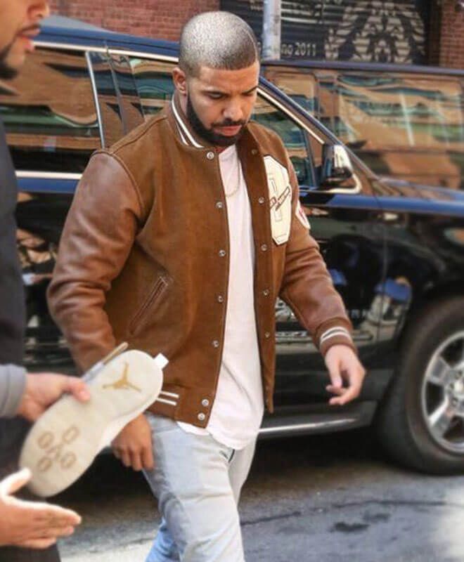 Drake Brown Lettermen Jacket Blending different genres ranging from rap to hip-hop, Drake’s music is highly influential, making him one of the top artists of this decade. Popularizing R&B, his impact on the pop culture community is undeniable, often garnering praise and topping charts for his songs about love, heartbreak, his lifestyle, and his ambitions. Due to his ginormous following, Drake is often seen as a fashion icon, with many of his fans trying to replicate his looks. Add the embodiment of casual chic to your wardrobe with the AlexGear brown varsity jacket, adored by the highly popular rapper Drake. Seeking inspiration from this iconic look, the Drake varsity jacket is perfect to be worn by young adults looking for outerwear showcasing functionality and practicality. Crafted by ou Retro Fall Outerwear For Streetwear, Brown Varsity Jacket For Winter Streetwear, Brown Winter Varsity Jacket For Streetwear, Brown Varsity Jacket For Streetwear, Hip Hop Long Sleeve Varsity Jacket For Fall, Brown Casual Varsity Jacket For Streetwear, Casual Brown Varsity Jacket For Streetwear, Fall Streetwear Varsity Jacket With Baseball Collar, Brown Hooded Varsity Jacket For Streetwear