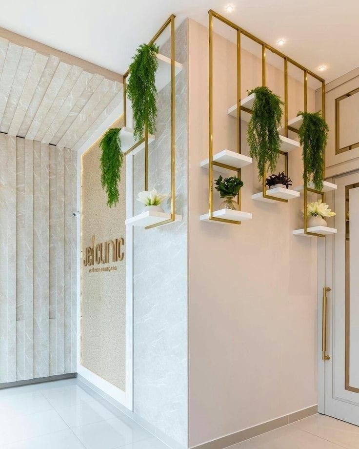 a white room with plants hanging from the wall and gold trimmings on the walls