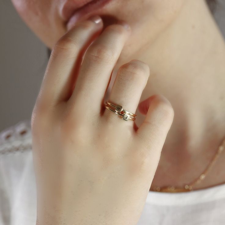 "A lovely personalized initial ring. Minimal, geometrical and modern look. Cute dainty ring is made of 14k solid yellow gold and initials engraving on the cube for your request. * Cube is 4x4mm and 2.5mm height. * Band is 1.3mm thick. * Only one character for each ring. Any initial is available from the drop down menu. TURN AROUND TIME This rings are custom made to orders so please allow us 1-2 weeks. RING SIZE : Please choose your ring size from drop down menu. --------------------------------- Minimalist Stackable Bypass Ring With Open Band, Adjustable 14k Gold Minimalist Bypass Ring, Minimalist Initial Promise Ring, Adjustable Modern Initial Ring In 14k Gold, Minimalist 14k Gold Bypass Ring For Anniversary, Minimalist Open Initial Ring For Promise, Modern Adjustable 14k Gold Initial Ring, 14k Gold Minimalist Bypass Ring With Ethical Diamonds, Minimalist Adjustable 14k Gold Bypass Ring