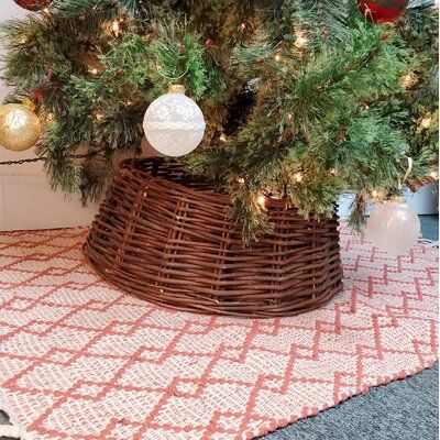 a dog is sitting in front of a christmas tree with ornaments on it's head