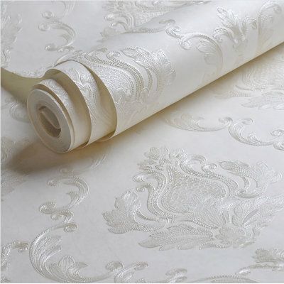 a roll of white wallpaper with an intricate design on the bottom and side of it