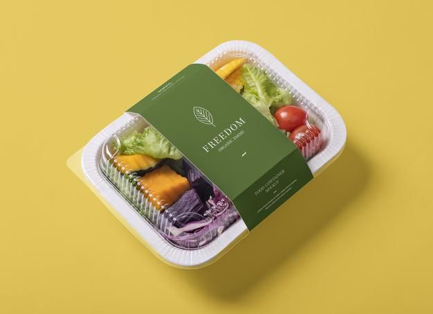 a plastic container filled with assorted fruits and vegetables on top of a yellow background