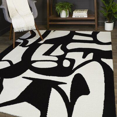 a black and white area rug in a living room