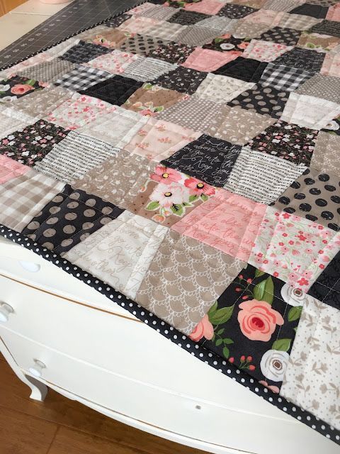 a quilted table top with flowers and polka dotes on it's edges