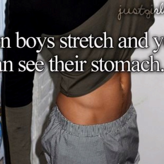 a man standing in front of a wall covered in stickers with the words, when boys stretch and you can see their stomach