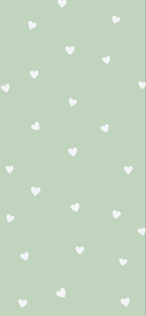 a green wall with white hearts on it