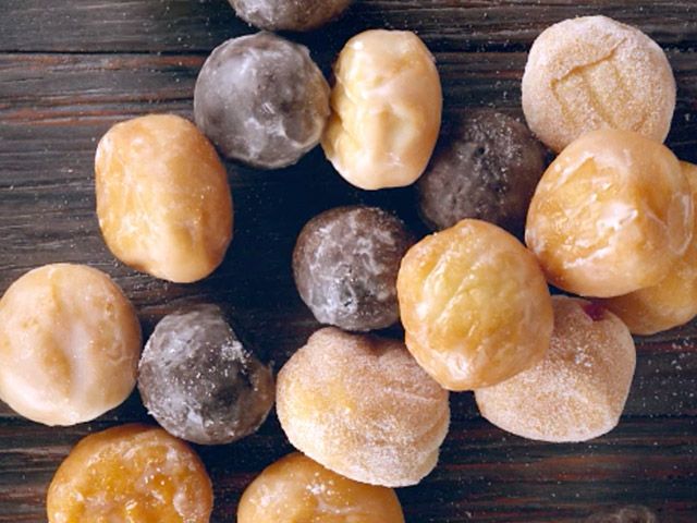 several different types of doughnuts on a wooden table