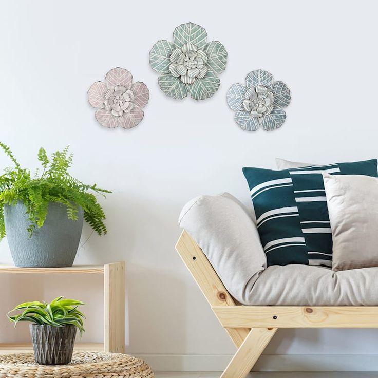 a living room with three decorative wall hangings on the wall