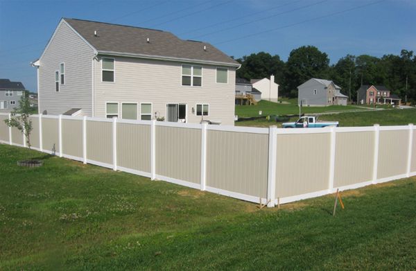 a white fence in front of a house