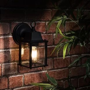 an outdoor light on a brick wall