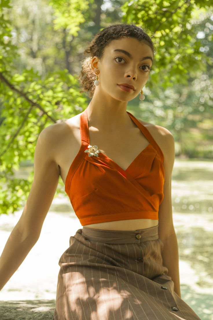 Add a pop of color to your wardrobe with this bright orange halter top that is sure to turn heads. Material | Dupioni Silk Blend Dry clean only Made in Los Angeles Items are made to order. Please allow 3-4 weeks for items to ship. Item shown is Size 6 Model is 5'9 Chic Cropped Orange Top, Fitted Halter Neck Blouse, Chic Fitted Orange Crop Top, Chic Orange Party Blouse, Fitted Orange Halter Top, Fitted Orange Tops, Fitted Halter Neck Blouse For Summer, Fitted Orange Halter Neck Top, Orange Sleeveless Halter Top For Party