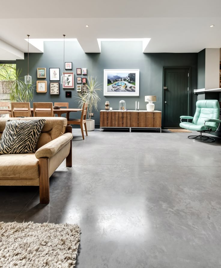 a living room filled with furniture and a skylight over the top of it's windows